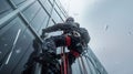 Industrial Climber Washing High-Rise Windows in the Snow. Generative ai