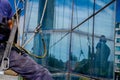 Industrial climber at work, cleaning facade of a modern office b Royalty Free Stock Photo