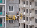 Industrial climbers work on the construction of the building facade, painting the exterior of the facade of a residential building