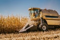 Industrial combine harvester working in the fields. Agriculture Farmer working with machinery Royalty Free Stock Photo