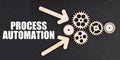 On the black surface, arrows, gears and an inscription - PROCESS AUTOMATION