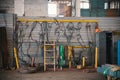 Industrial concept. Constructing lifting crane in the plant. Metal cables on the wall