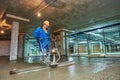 Concrete floor construction. Worker with screeder