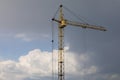 Industrial construction building crane against grey cloudy sky Royalty Free Stock Photo