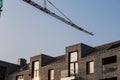 Industrial construction close-up of a crane against blue sky in the background - building site progress architecture Royalty Free Stock Photo