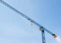 Industrial construction crane hoisting against blue sky