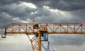 Industrial construction cranes and building silhouettes over sun at sunrise Royalty Free Stock Photo