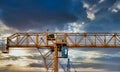 Industrial construction cranes and building silhouettes over sun at sunrise Royalty Free Stock Photo