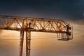 Industrial construction cranes and building silhouettes over sun at sunrise Royalty Free Stock Photo