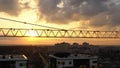 Industrial construction cranes and building silhouettes over sunset background and sunrise