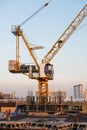 Industrial construction cranes, and under construction site building in the city Royalty Free Stock Photo