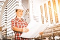 Industrial construction engineer wear safety helmet engineering working inspection and smile on building outside office.