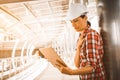 Industrial construction engineer wear safety helmet engineering working and using digital tablet on building outside.