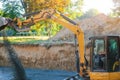 Industrial construction site excavator moving gravel and rocks for foundation building Royalty Free Stock Photo