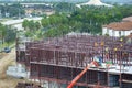 Industrial construction site with workers assembling metal frame building. Development of residential housing in America Royalty Free Stock Photo