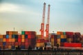 Industrial cranes loading freight containers for cargo ships. Royalty Free Stock Photo