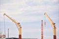 Industrial Cranes Hovering Over Cargo Operations at a Working Harbor Royalty Free Stock Photo