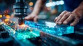 Industrial cutting machine processing a glowing glass block as a worker steadies the material during precision Royalty Free Stock Photo