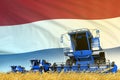 Industrial 3D illustration of blue farm agricultural combine harvester on field with Netherlands flag background, food industry