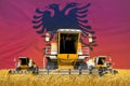 industrial 3D illustration of four orange combine harvesters on rural field with flag background, Albania agriculture concept