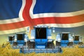 Industrial 3D illustration of some blue farming combine harvesters on rye field with Iceland flag background - front view, stop