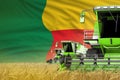 industrial 3D illustration of three green modern combine harvesters with Benin flag on farm field - close view, farming concept