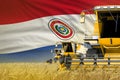 industrial 3D illustration of three yellow modern combine harvesters with Paraguay flag on farm field - close view, farming