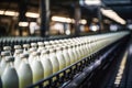 Industrial dairy: automated machinery on a conveyor, filling rows of plastic milk bottles