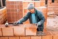 Construction bricklayer worker building walls with bricks, mortar and putty knife Royalty Free Stock Photo