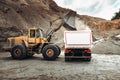 Industrial dumper trucks and wheel loader bulldozer working on highway construction site, loading and unloading gravel and earth m Royalty Free Stock Photo