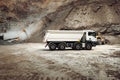 Industrial dumper trucks working on highway construction site, loading and unloading gravel and earth. heavy duty machinery activi Royalty Free Stock Photo