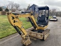 Industrial earth digger excavator parked on a road in a residential neightborhood Royalty Free Stock Photo