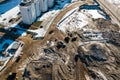 Industrial earthworks loader bucket machines on building construction site. Shot from above