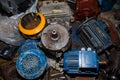 Industrial electric motors in a garage on a rack. Electrical equipment under repair, dirty asynchronous current generators Royalty Free Stock Photo