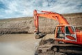 Industrial engineer working with excavator during highway construction site, loading dumper trucks and building viaduct and bridge Royalty Free Stock Photo