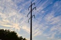 Industrial environment from evening to dawn time. Countryside romantic view with trees silhouettes, electricity pillars and wires Royalty Free Stock Photo