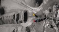 Industrial excavator dump stone, crushed stone or sand truck loading process. Aerial top view Royalty Free Stock Photo