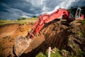 Industrial excavator loading soil from highway construction site