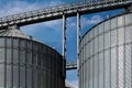 Industrial facilities of feed and flour mills. Close-up of steel grain storage silos with conical bottom, can be used for various