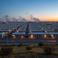 Industrial facility at dusk, featuring numerous rows of rectangula Royalty Free Stock Photo