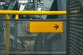 Yellow empty direction sign with black arrow