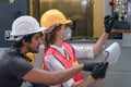 Industrial or factory engineering worker and supervisor setting up computerized control panel of factory assembly line controller Royalty Free Stock Photo