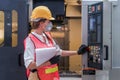 Industrial or factory engineering worker and supervisor setting up computerized control panel of factory assembly line controller Royalty Free Stock Photo