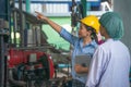 Industrial factory inspector standing with process worker near stream machine Royalty Free Stock Photo