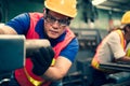 The industrial factory inspector wearing safety helmet and goggle watching on factory equipments to keep tracking safety work in