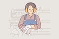 Industrial factory worker man in headphones protecting ears stands near milling machine
