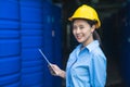 Industrial factory worker with yellow hardhat standing and holding tablet Royalty Free Stock Photo