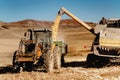 Industrial farmer using combine harvester and tractor for autumn harvest Royalty Free Stock Photo