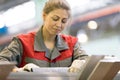 Industrial female worker on manufacture workshop background