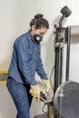 Industrial female worker with protective mask and leather gloves